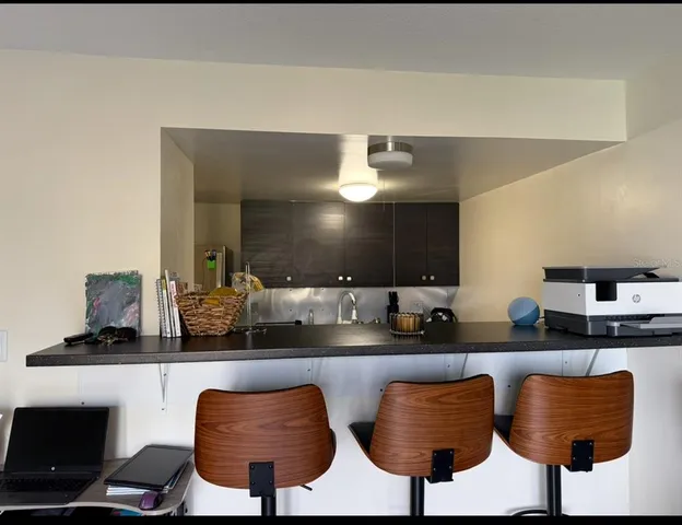 a kitchen with stainless steel appliances granite countertop a sink and a stove