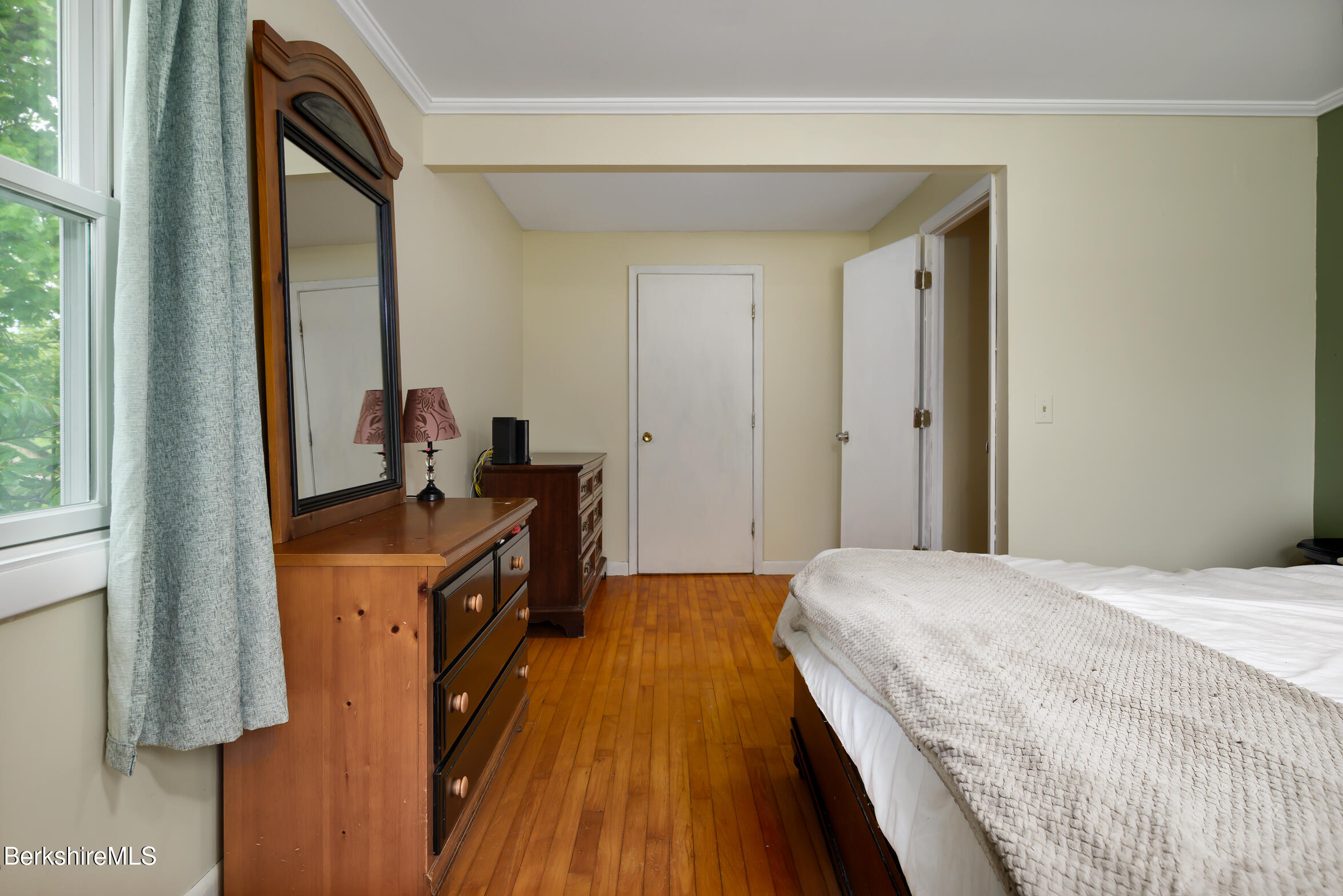 310 Luce Road Williamstown, MA 01267 - Photo 22 of 30 a bedroom with a bed and dresser with mirror