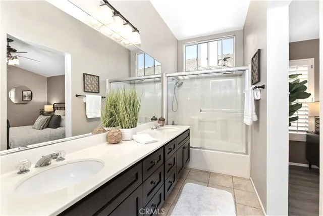 a bathroom with a double vanity sink a mirror and shower