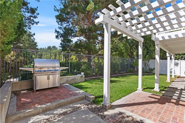 a backyard of a house with a fountain table and chairs