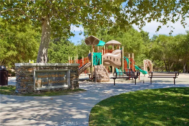 a view of outdoor space with playground and green space