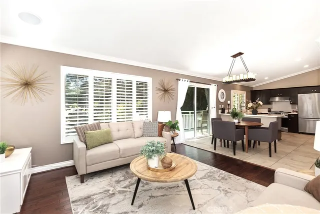 a living room with furniture a window and a dining table