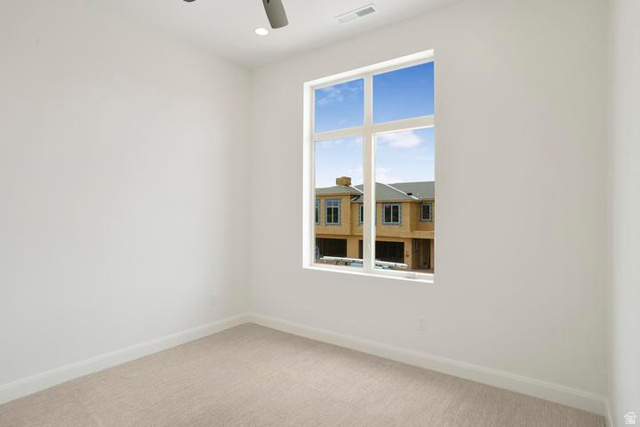 990 Manen Street Washington, UT 84780 - Photo 31 of 43 Bright room featuring a large multi-pane window, neutral-toned carpeting, white baseboards, and recessed ceiling lighting