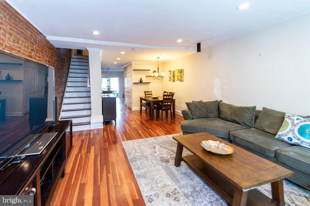 a living room with furniture and kitchen view