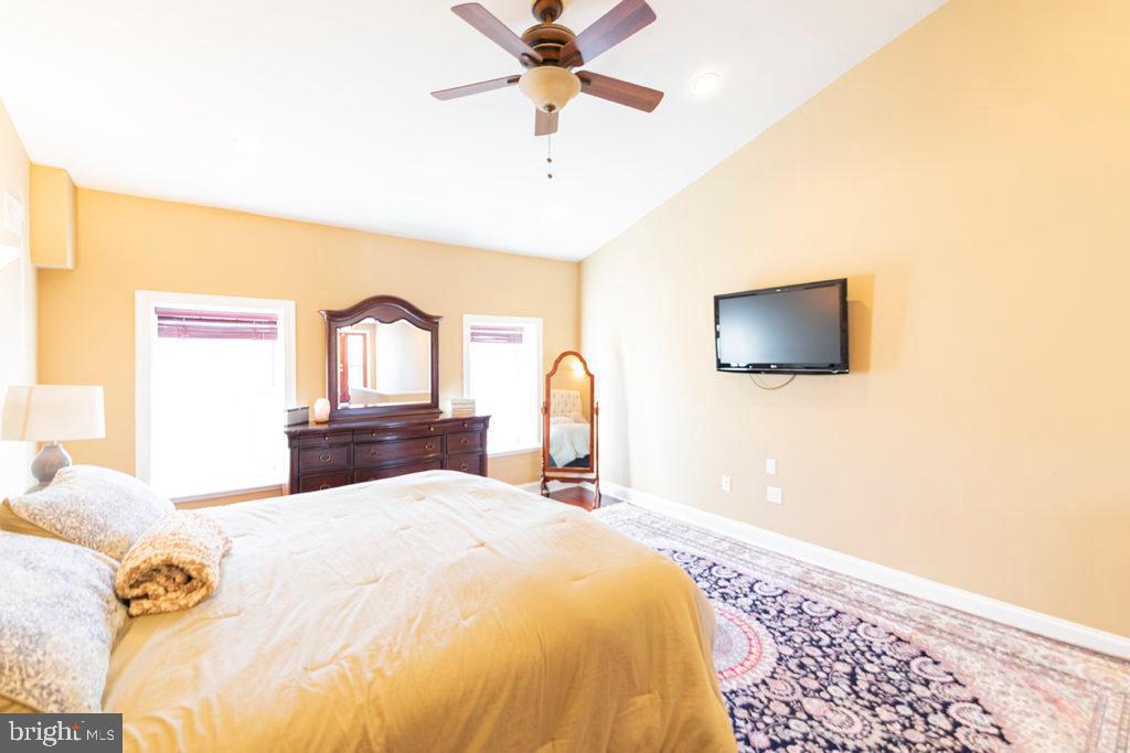 2107 Carpenter Street Philadelphia, PA 19146 - Photo 14 of 24 a bedroom with a bed and a chandelier