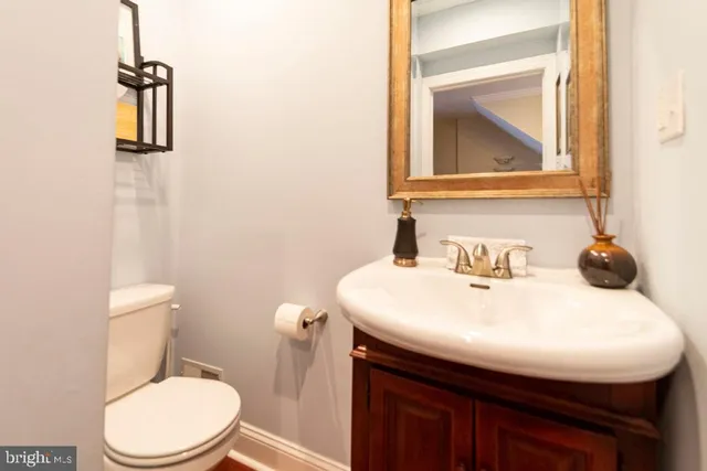 a bathroom with a toilet sink and mirror