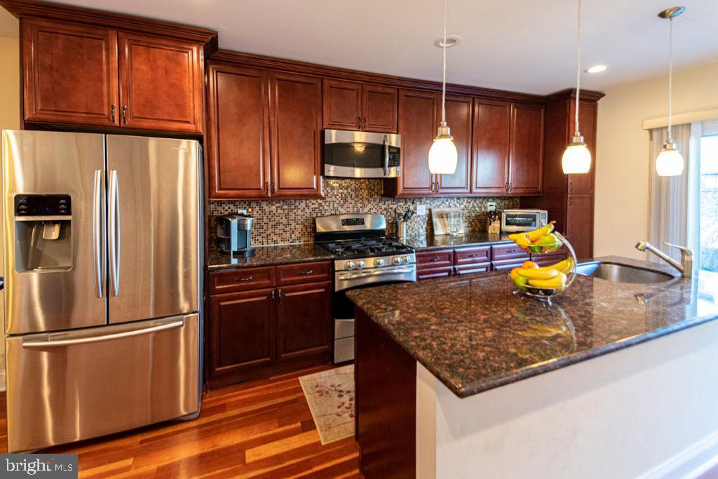 2107 Carpenter Street Philadelphia, PA 19146 - Photo 3 of 24 a kitchen with stainless steel appliances granite countertop a refrigerator a stove top oven a sink and dishwasher