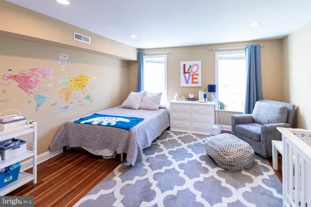 a bedroom with a bed and a couch