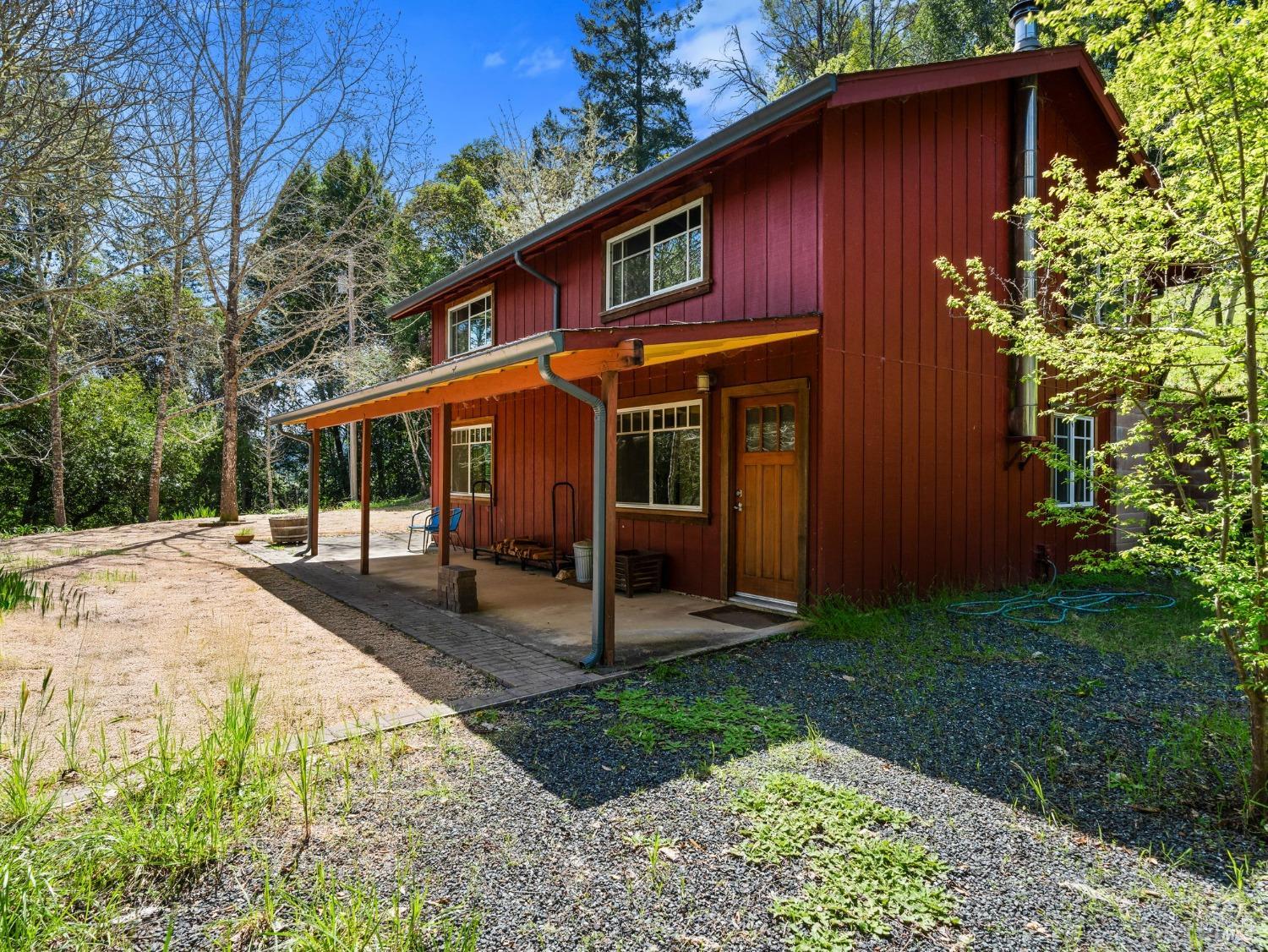 a view of a house with backyard and sitting area