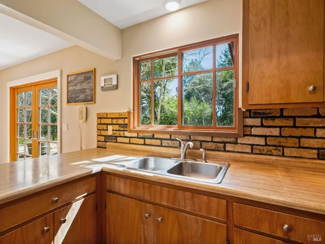a kitchen with a sink and large window