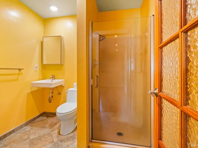 a bathroom with a toilet shower and a sink
