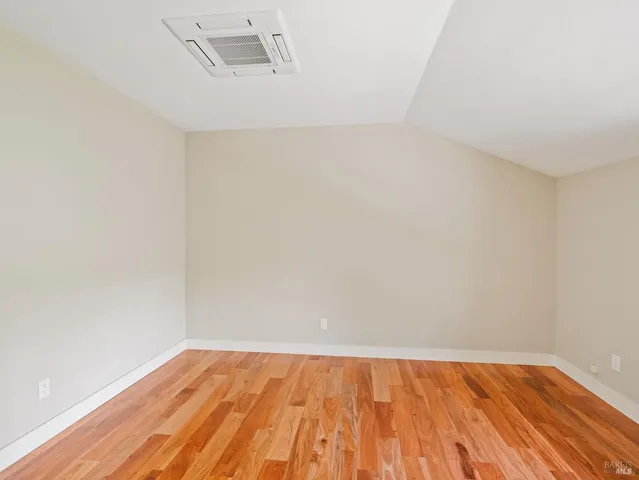 a view of a room with wooden floor