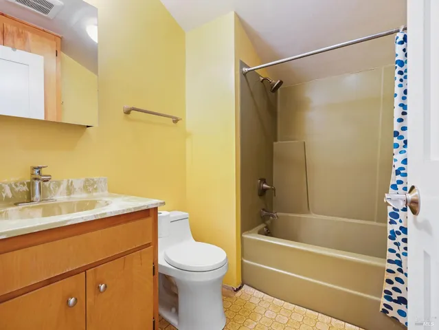 a bathroom with a sink a mirror toilet and bathtub