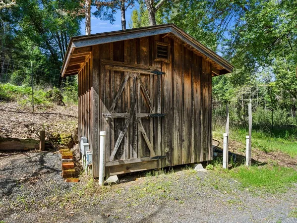a view of wooden house with a yard
