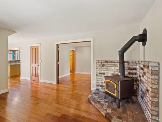 a view of a living room with furniture and wooden floor