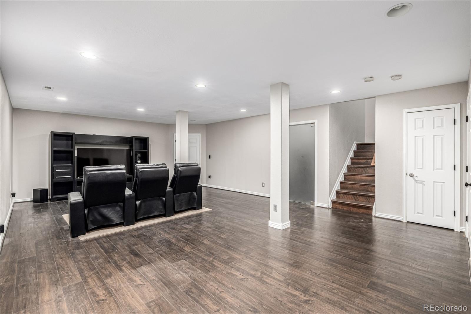 15501 East 112th Avenue, Unit 34C Commerce City, CO 80022 - Photo 14 of 18 a living room with furniture and a wooden floor