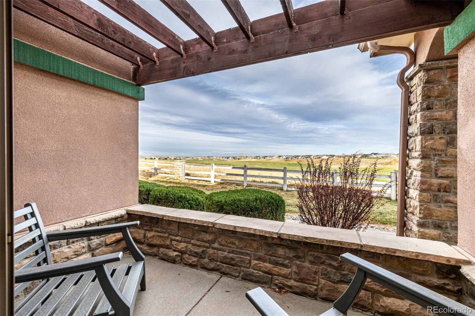 15501 East 112th Avenue, Unit 34C Commerce City, CO 80022 - Photo 3 of 18 a view of a chairs and table in a balcony