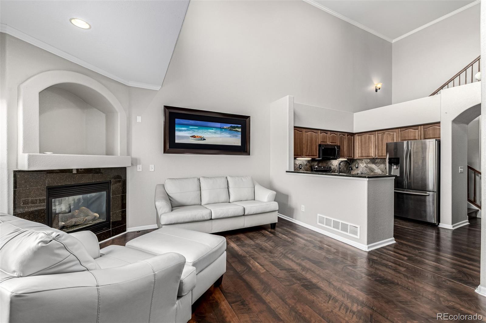 15501 East 112th Avenue, Unit 34C Commerce City, CO 80022 - Photo 4 of 18 a living room with furniture and a fireplace