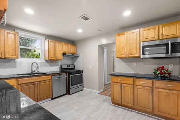 a kitchen with sink cabinets and window