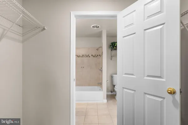 a bathroom with a glass shower door and a mirror