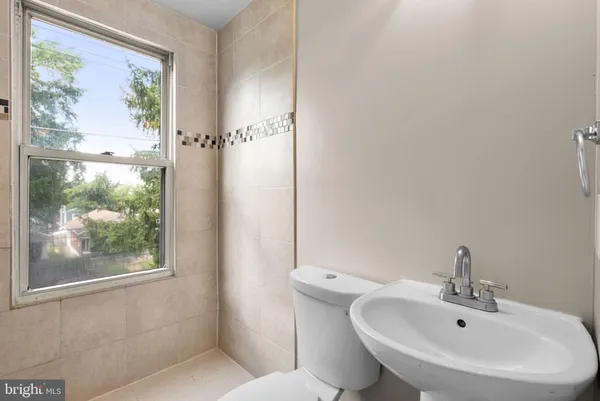 a bathroom with a sink and mirror with toilet