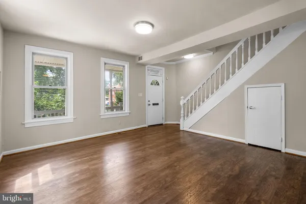 a view of an entryway with wooden floor