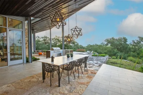 a backyard of a house with table and chairs