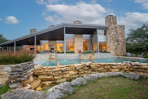 a view of a lake with couches in patio