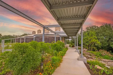 a living room with furniture and floor to ceiling windows