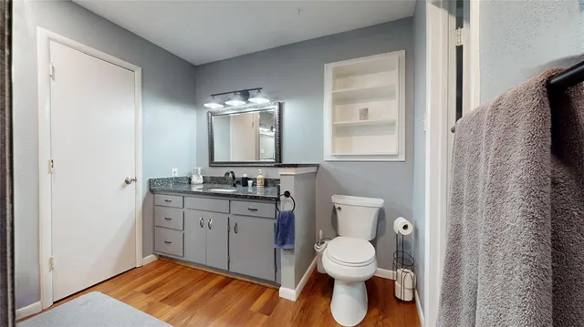 a spacious bathroom with a toilet sink and mirror
