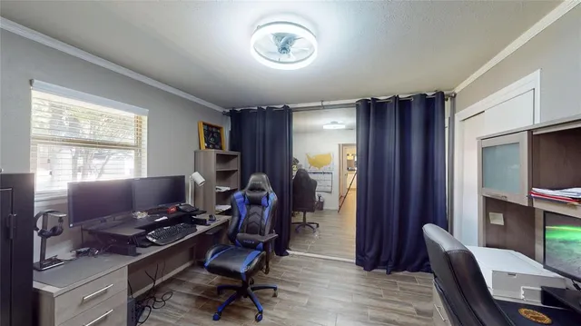 a view of a workspace with furniture and a window