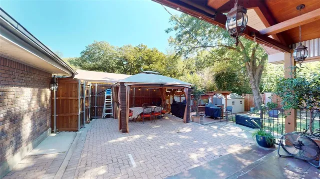 a view of house with backyard space and glass windows
