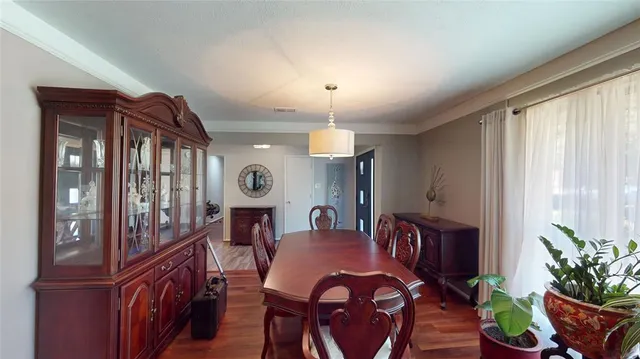 a view of a dining room with furniture and window