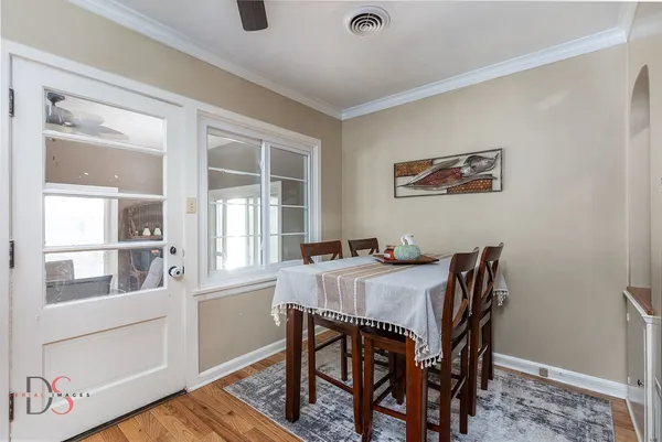 a view of a dining room with furniture window and wooden floor