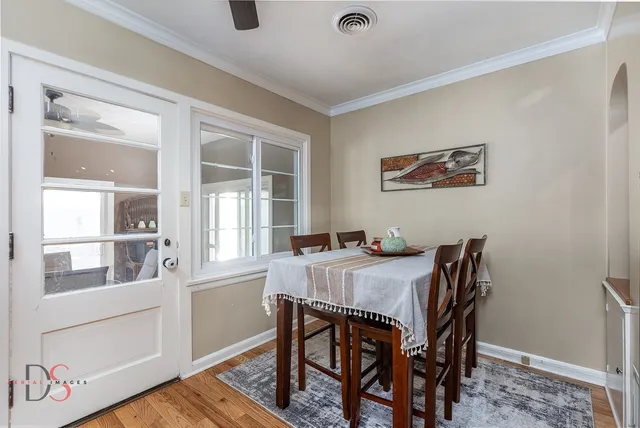 a view of a dining room with furniture window and wooden floor