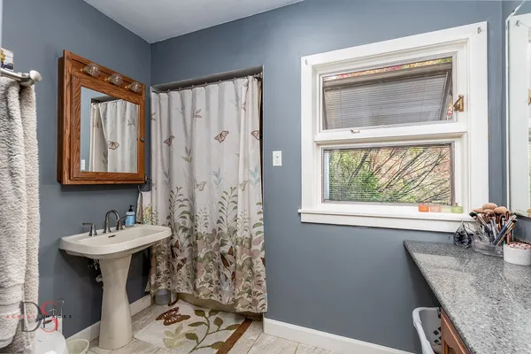 a bathroom with a sink toilet and a mirror