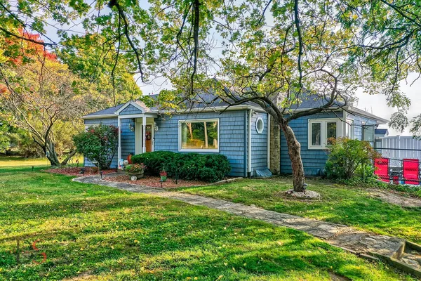 a front view of house with yard and green space