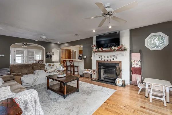 a living room with furniture a flat screen tv and a fireplace