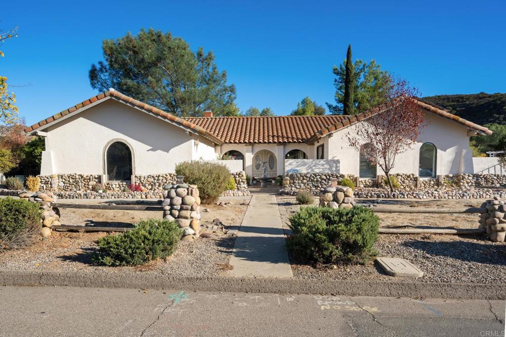 a front view of a house with a garden