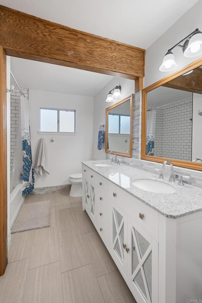 16273 Arena Drive Ramona, CA 92065 - Photo 32 of 67 a spacious bathroom with a granite countertop sink and a mirror