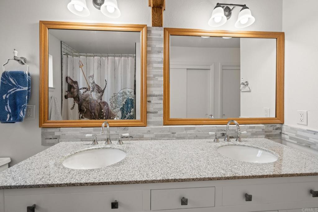16273 Arena Drive Ramona, CA 92065 - Photo 33 of 67 a bathroom with sink granite and a mirror