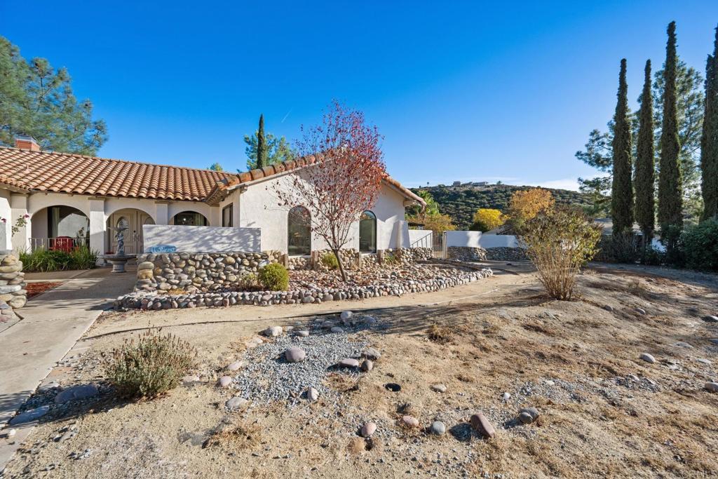 16273 Arena Drive Ramona, CA 92065 - Photo 5 of 67 a front view of a house with a garden