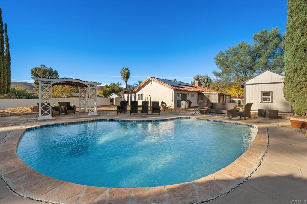 16273 Arena Drive Ramona, CA 92065 - Photo 65 of 67 a view of a swimming pool with a lounge chairs