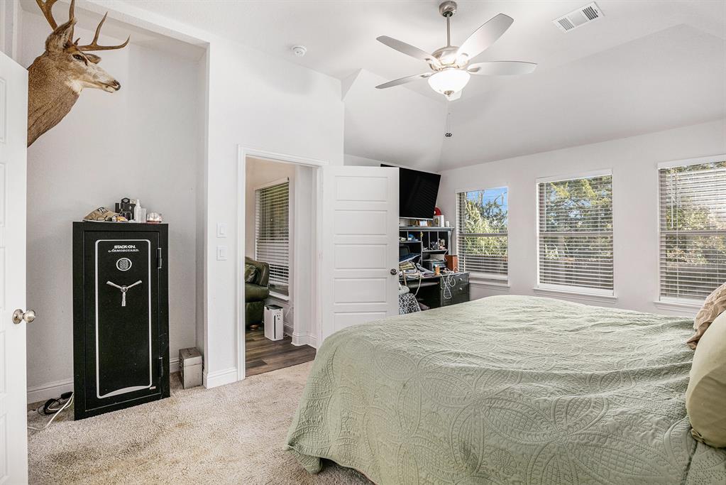 417 Elyse Road Keene, TX 76059 - Photo 11 of 17 a large white bed in a spacious bedroom and a chandelier