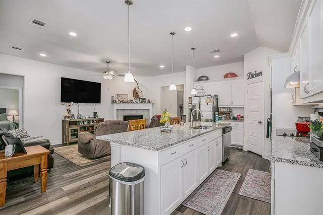 a large kitchen with sink a stove and cabinets