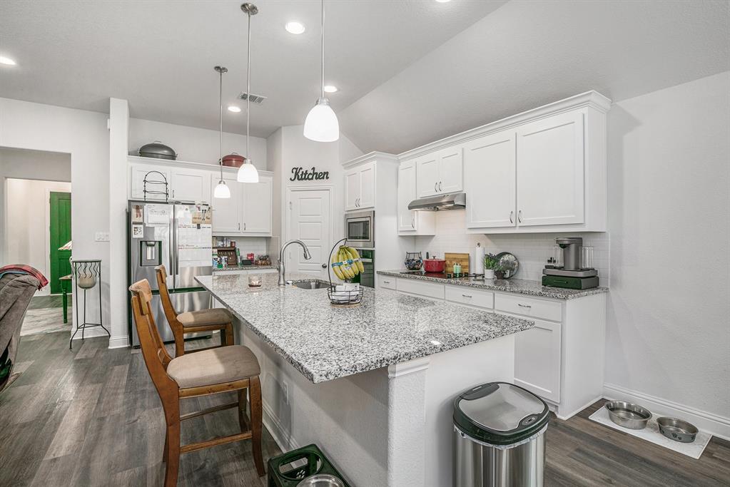 417 Elyse Road Keene, TX 76059 - Photo 15 of 34 a kitchen with a stove and chairs