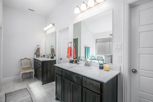 a bathroom with a sink and a mirror with toilet