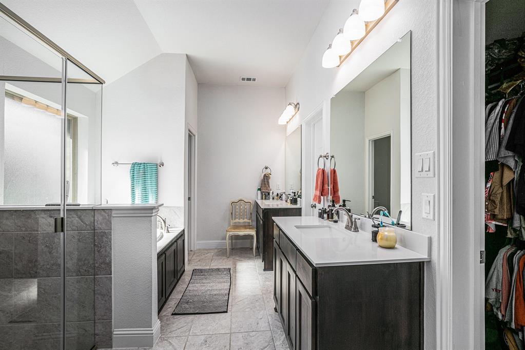417 Elyse Road Keene, TX 76059 - Photo 21 of 34 a en suite bathroom with a sink vanity and mirror