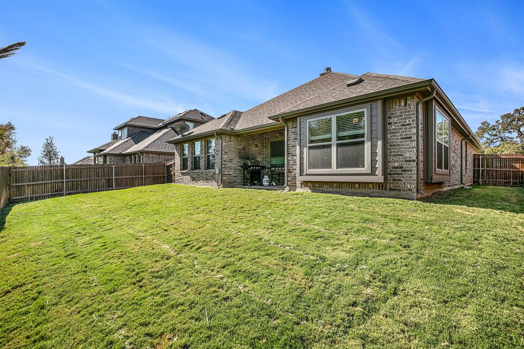 417 Elyse Road Keene, TX 76059 - Photo 6 of 17 a front view of a house with a garden