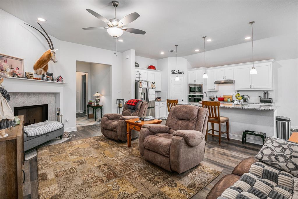417 Elyse Road Keene, TX 76059 - Photo 8 of 34 a living room with furniture fireplace and kitchen view